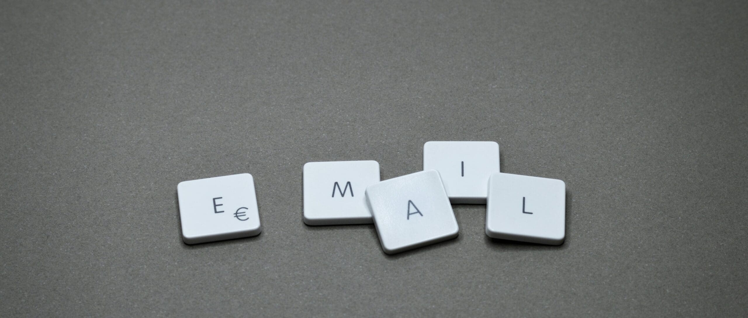 White keyboard keys spelling EMAIL on gray background representing Klaviyo setup for Shopify email marketing automation